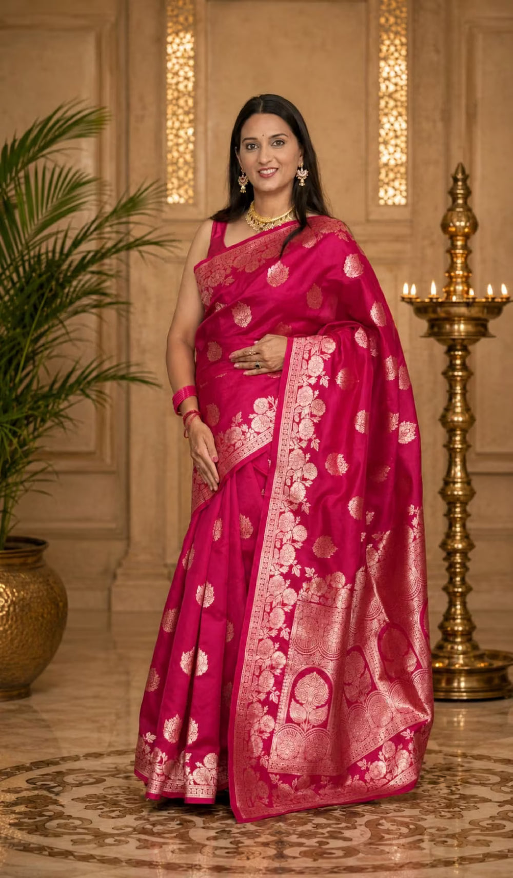 Woman in Rani Pink floral jacquard saree.