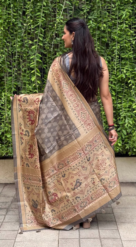 Woman wearing grey bandhani print saree by Ethnic Today.