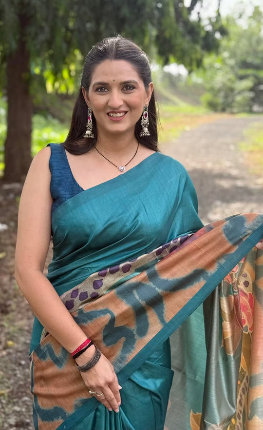 Woman in Peacock Blue Floral Tussar Silk Saree .
