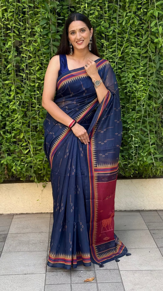 Woman in chanderi silk navy blue saree with wildlife print maroon pallu
