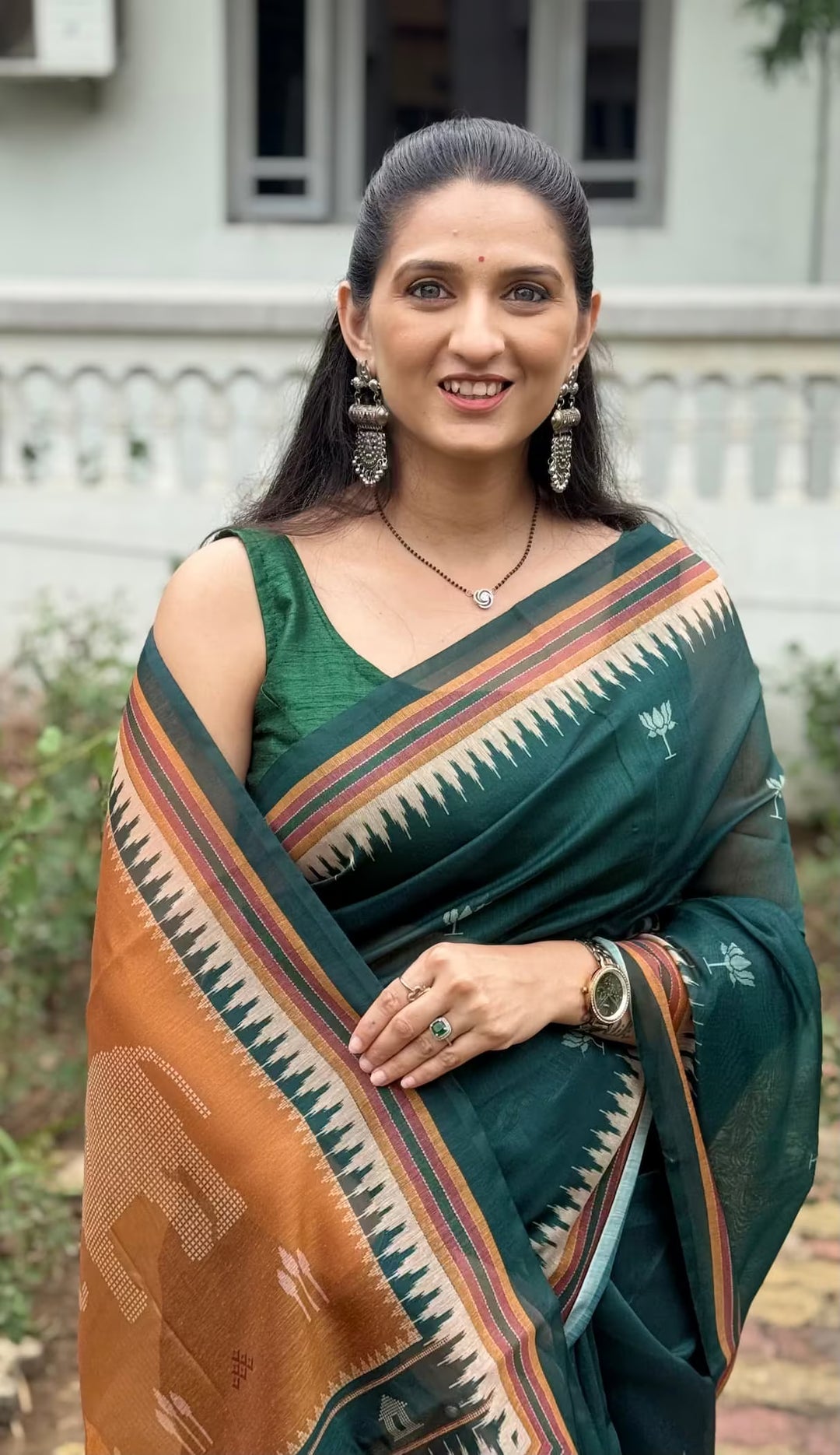 Woman wearing Bottle Green Lotus Butti Chanderi silk saree.