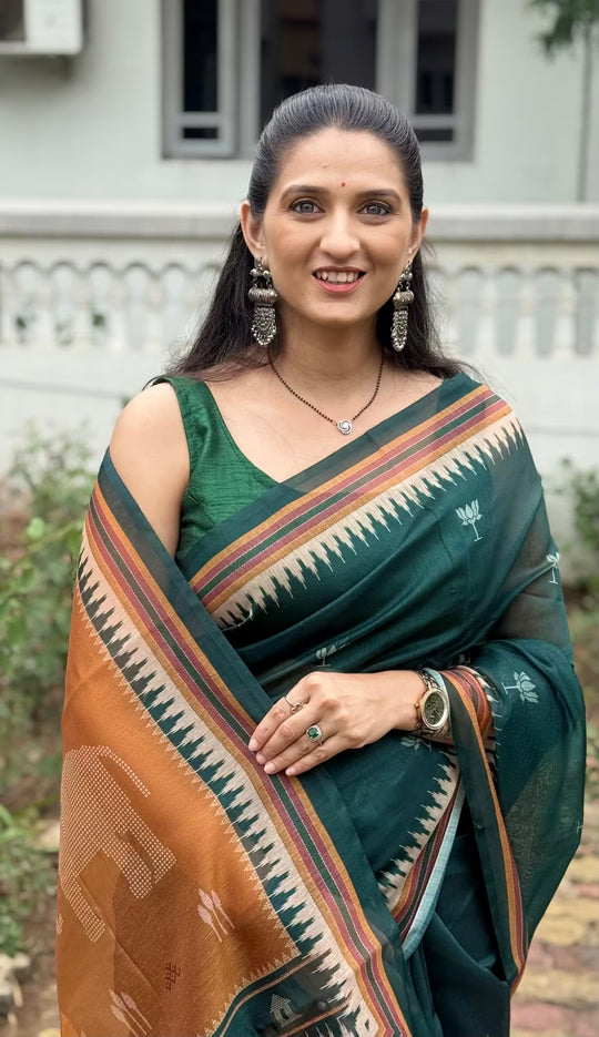 Woman wearing Bottle Green Lotus Butti Chanderi silk saree.
