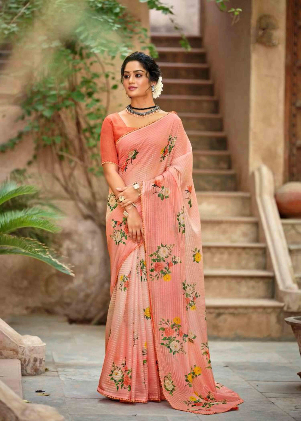 Woman in Light Orange Crochet work Saree.