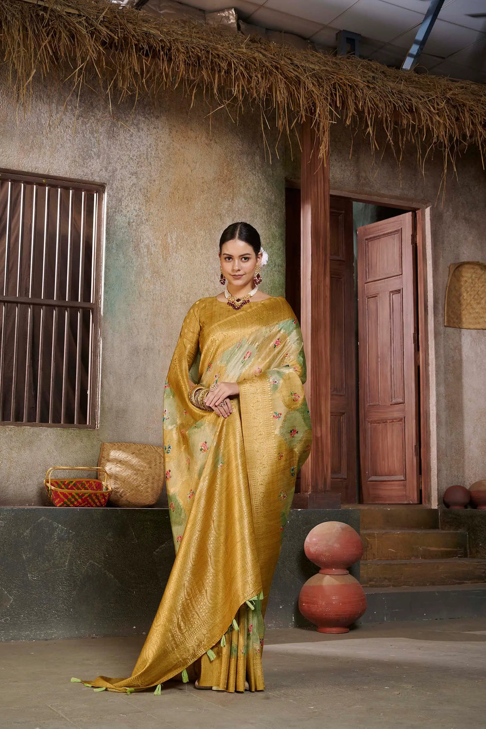 Woman in a yellow Position print saree.