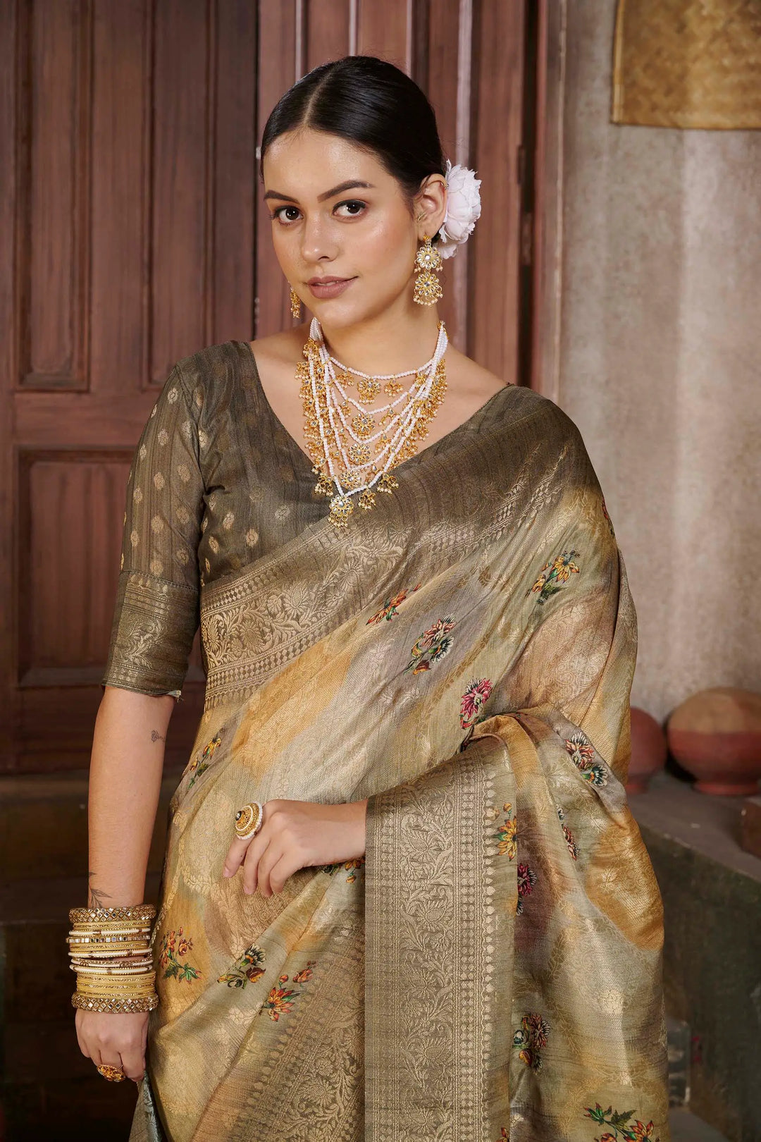 Woman in Coffee color Position print saree.