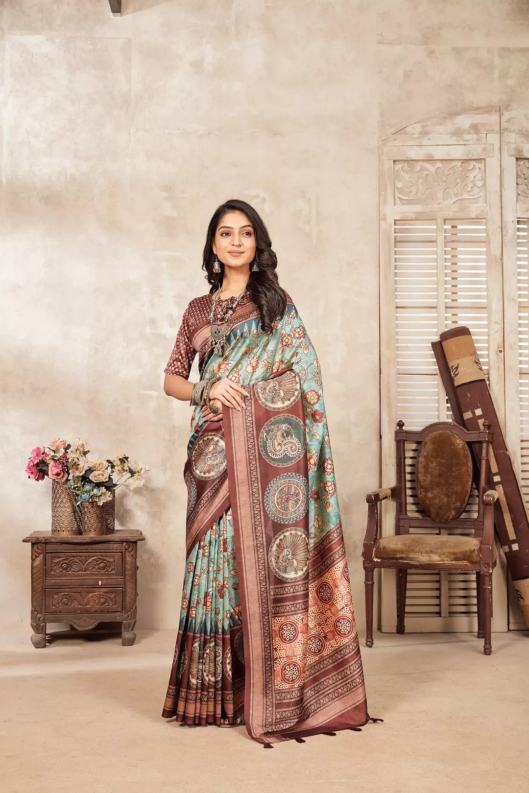 Woman wearing a Ajrakh pallu Kalamkari zal pattern Dia Silk saree.